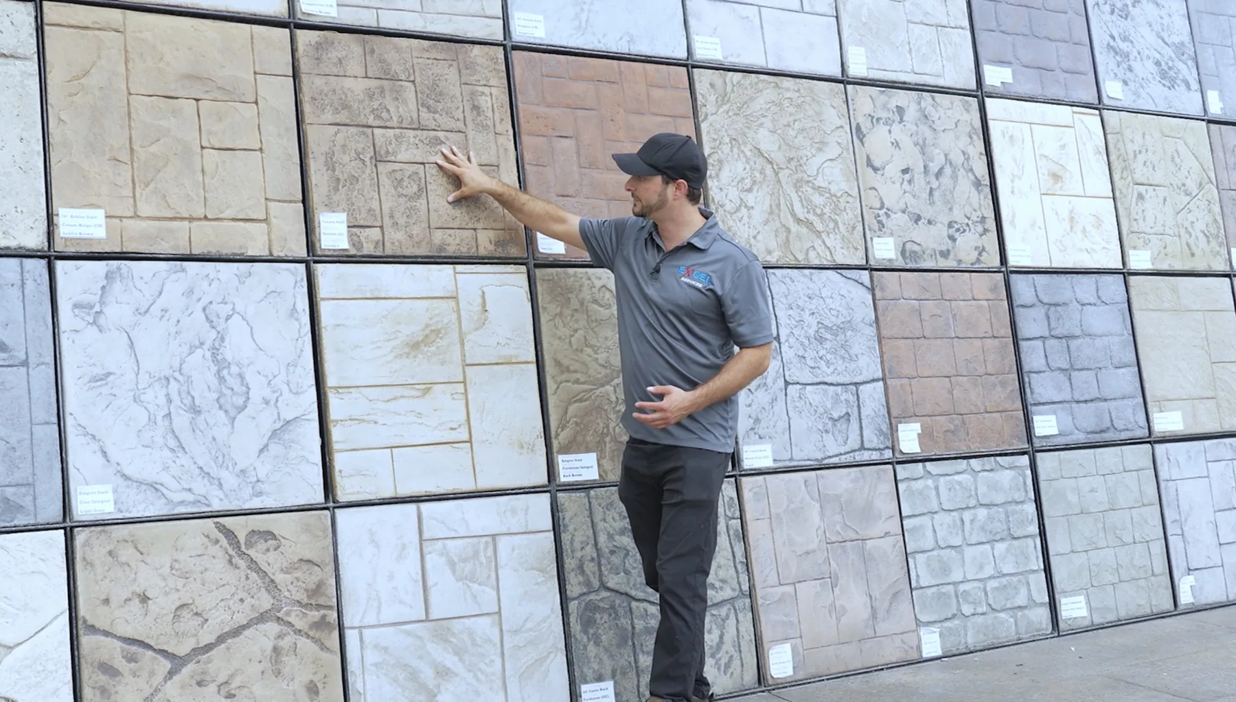 Excel Management representative demonstrating construction finish options during a business video shoot